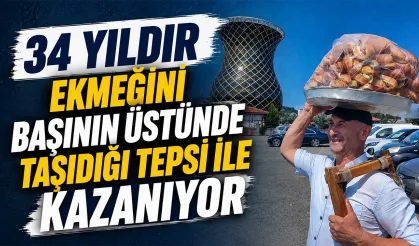 Ekmeği başının üstünde, yüzü hep gülüyor..